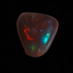 image is of a boulder opal with bright green, blue and red flecks