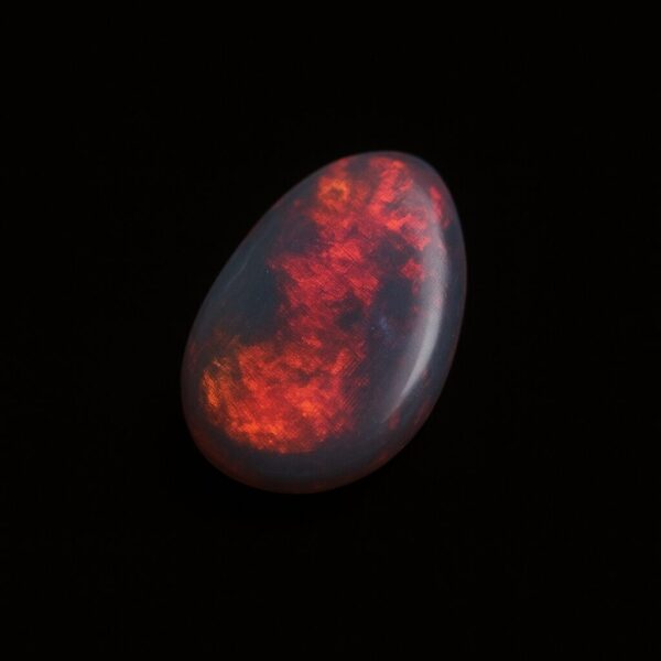 Image is of a boulder opal doublet with bright red hues