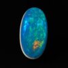 Image is of a boulder opal doublet with rainbow hues of colours