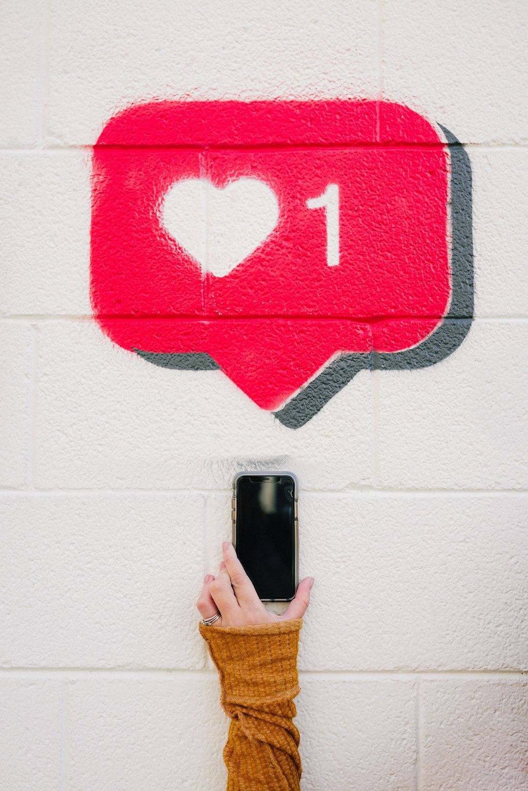image is of a love heart and a phone taking a picture 