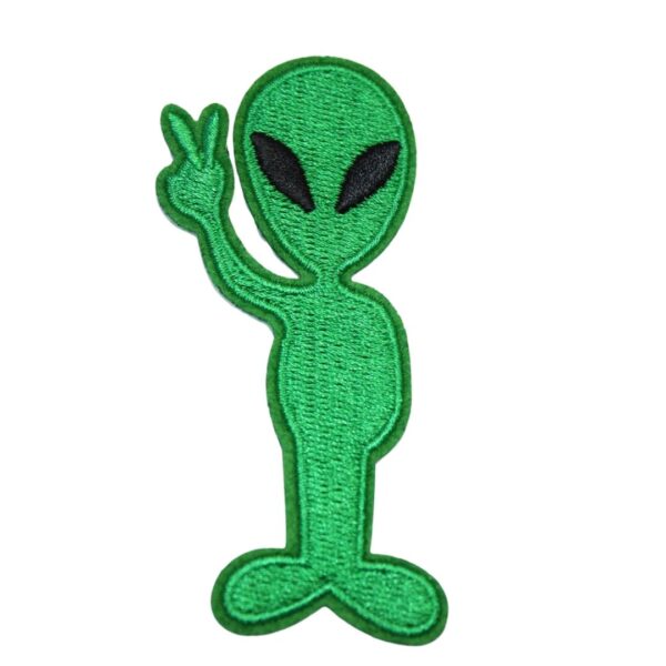 A Alien embroided iron on patch, perfect for personalizing clothing, bags, and accessories. Easy to apply with heat, adding a retro touch to any project.