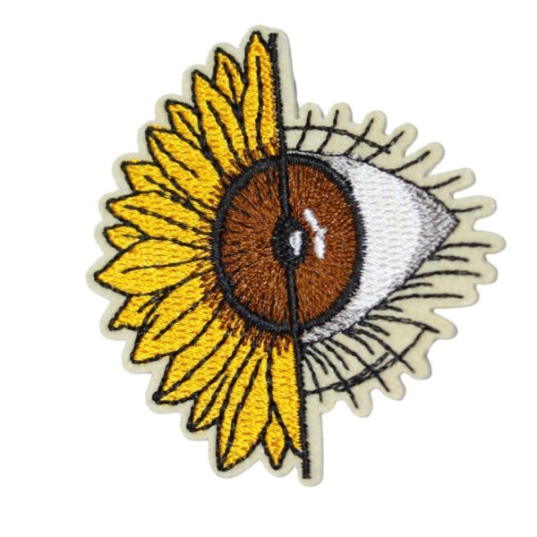 A SUNFLOWER EYE embroided iron on patch, perfect for personalizing clothing, bags, and accessories. Easy to apply with heat, adding a retro touch to any project.