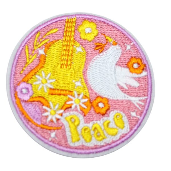 A Iron On Patch Embroidered PEACE, perfect for personalizing clothing, bags, and accessories. Easy to apply with heat, adding a retro touch to any project.