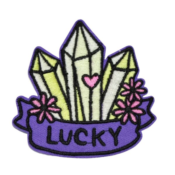 A LUCKY embroided iron on patch, perfect for personalizing clothing, bags, and accessories. Easy to apply with heat, adding a retro touch to any project.