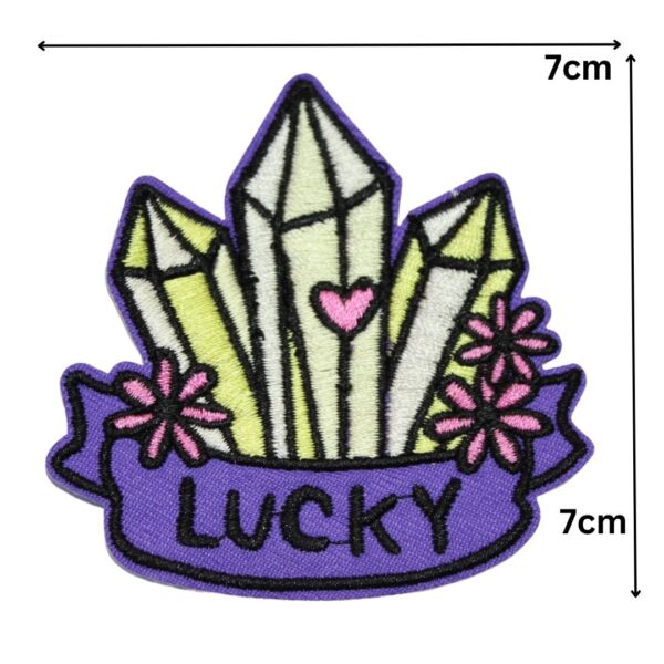 A LUCKY embroided iron on patch, perfect for personalizing clothing, bags, and accessories. Easy to apply with heat, adding a retro touch to any project.