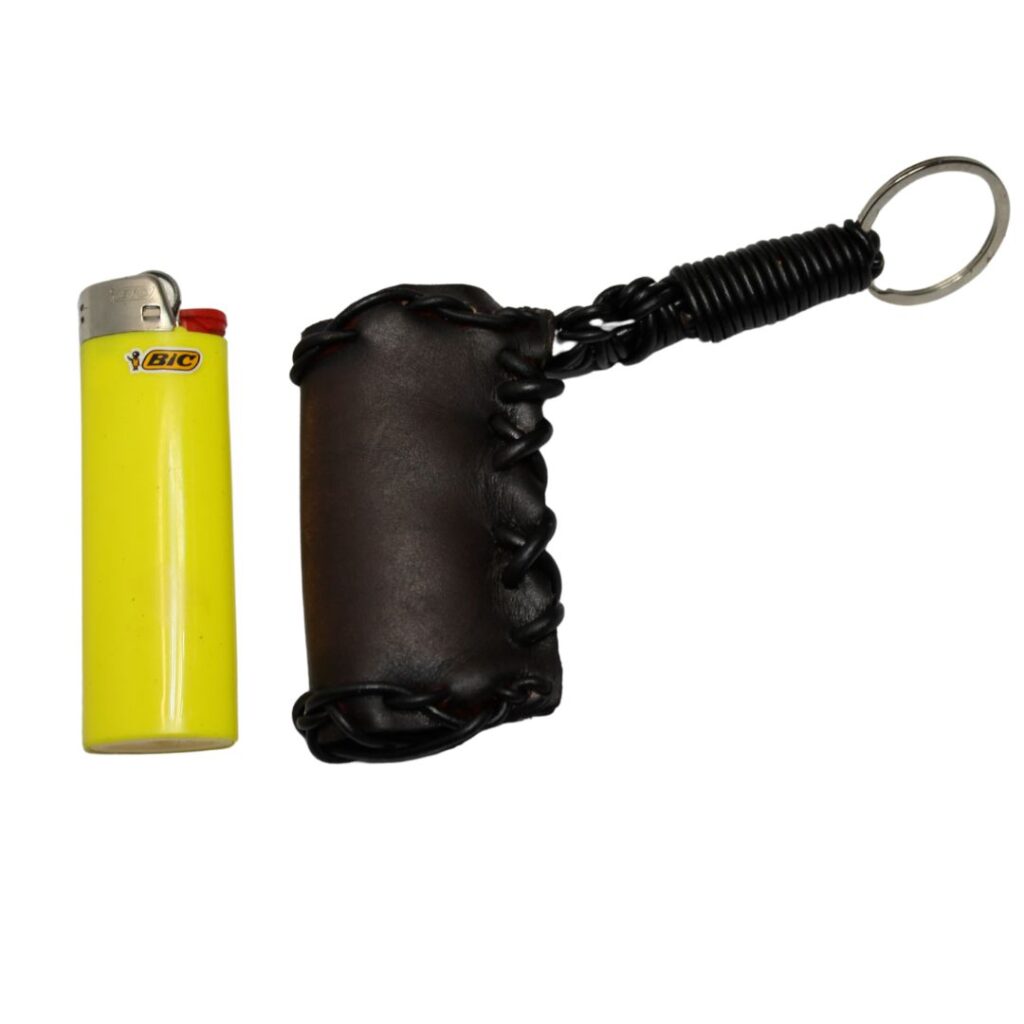 Image is of a leather lighter pouch holder with a keyring and a yellow lighter