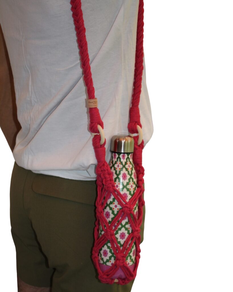 Image is of a woman holding a bright pink water bottle bag on shoulder 